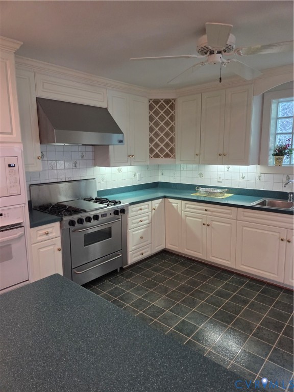 7733 Rock Creek Road Henrico, VA 23229 - Photo 17 of 73 a kitchen with stainless steel appliances a sink stove and cabinets