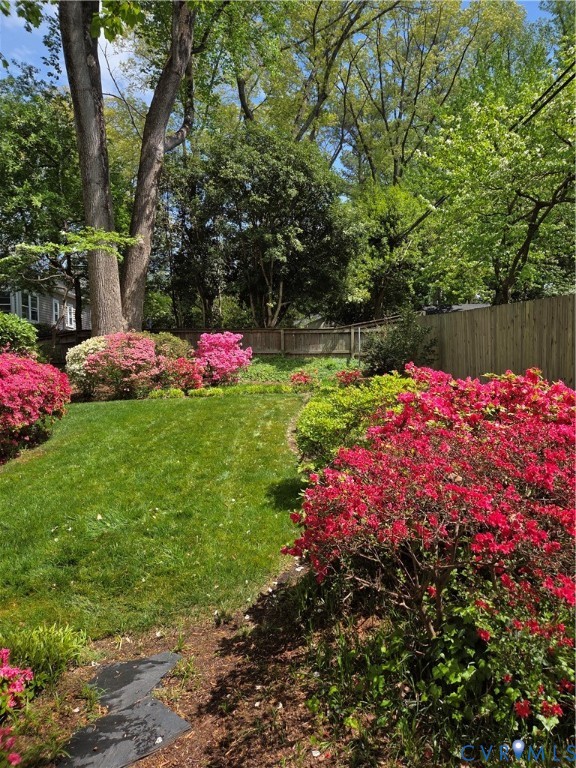 7733 Rock Creek Road Henrico, VA 23229 - Photo 34 of 73 a backyard of a house with table and chairs and wooden fence