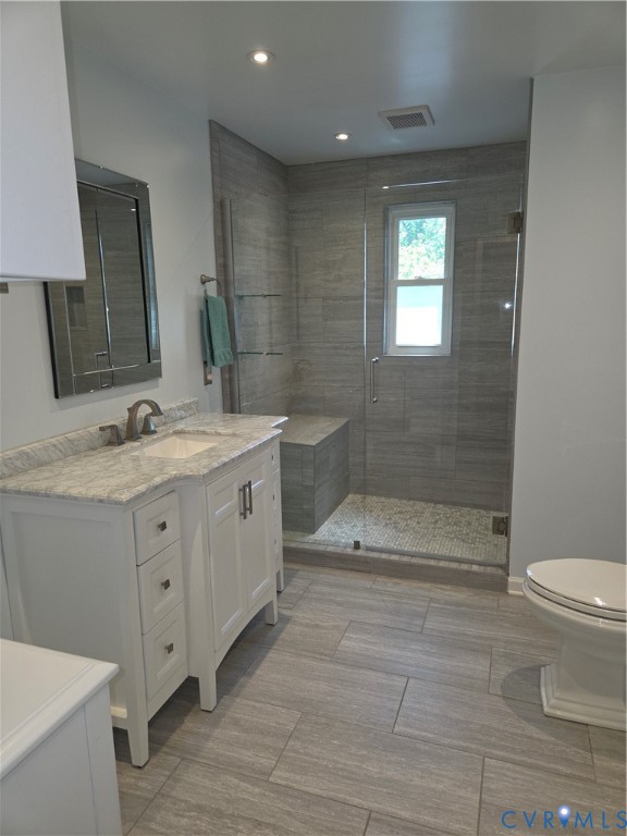 7733 Rock Creek Road Henrico, VA 23229 - Photo 60 of 73 a bathroom with a double vanity sink toilet and shower
