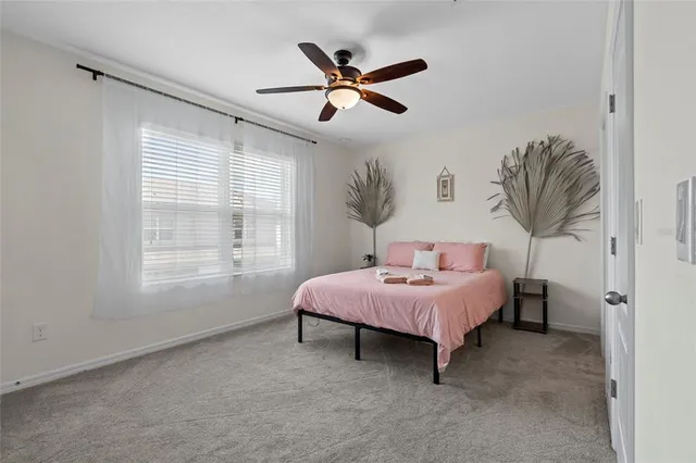 a spacious bedroom with a bed and a window