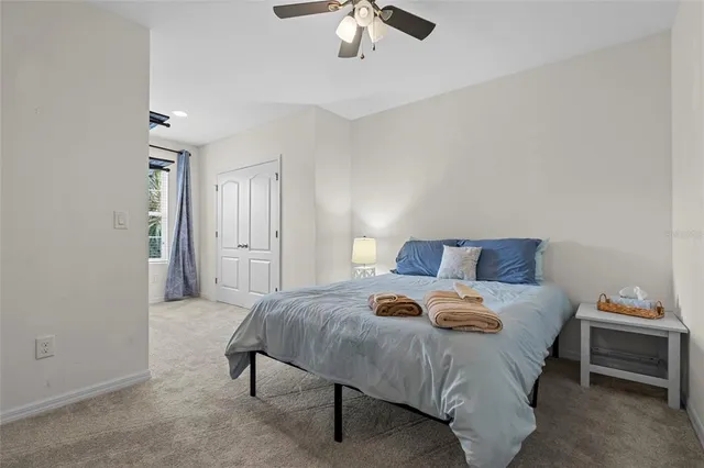 a bedroom with bed and a chandelier