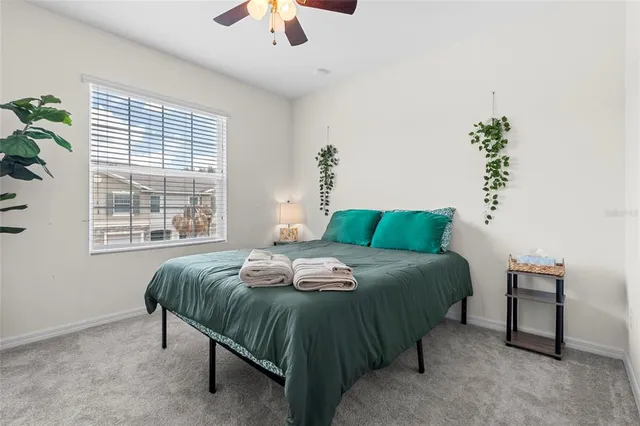 a bedroom with a bed lamps and window