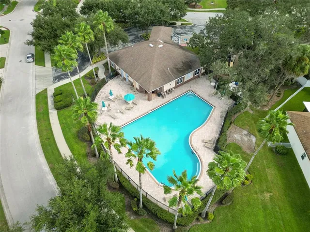 an aerial view of a house with swimming pool garden and patio