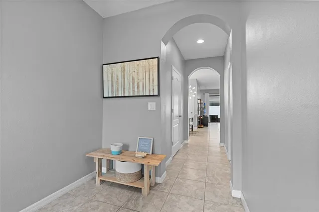 a view of a hallway with wooden floor and furniture
