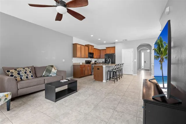 a living room with furniture and kitchen view