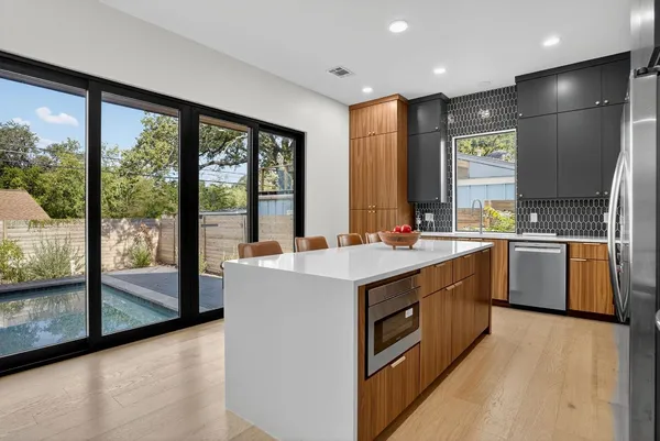 a kitchen with a sink stove and cabinets