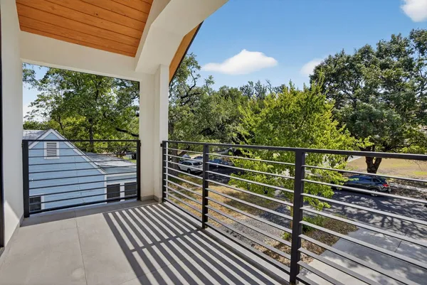 a view of a balcony with wooden floor and fence