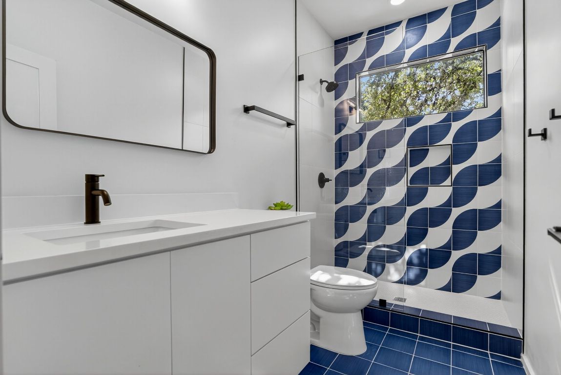 2316 Euclid Avenue Austin, TX 78704 - Photo 27 of 40 a bathroom with a sink a toilet a mirror and shower