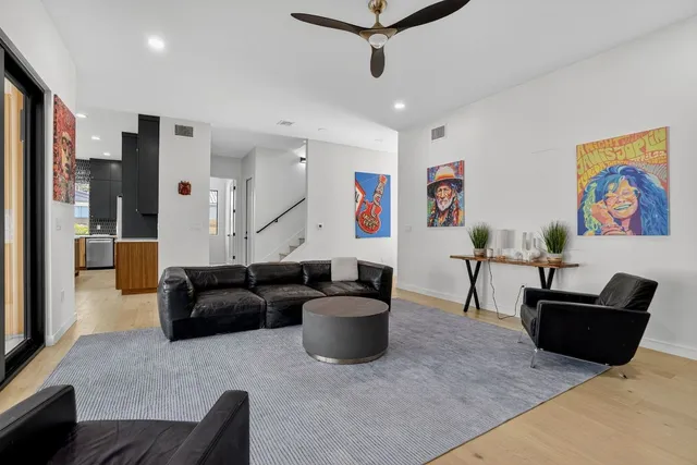 a kitchen with stainless steel appliances kitchen island granite countertop a sink and a refrigerator