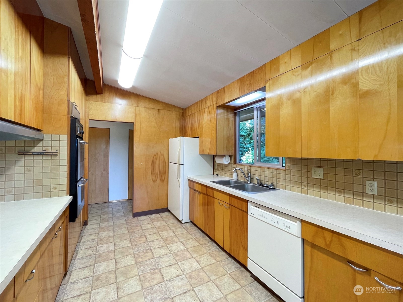 4217 South Bean Road Port Angeles, WA 98363 - Photo 12 of 40 a kitchen with stainless steel appliances granite countertop a sink and cabinets