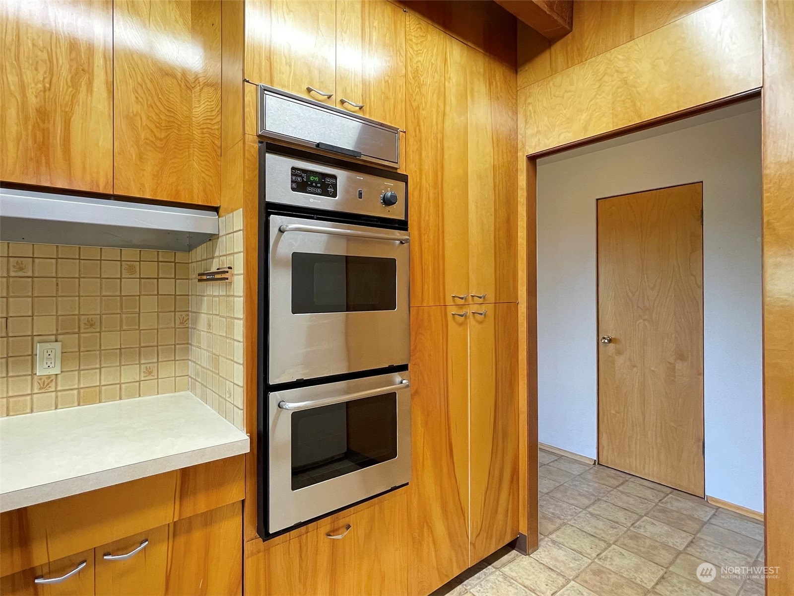 4217 South Bean Road Port Angeles, WA 98363 - Photo 13 of 40 a kitchen with stainless steel appliances kitchen island granite countertop a refrigerator and a stove