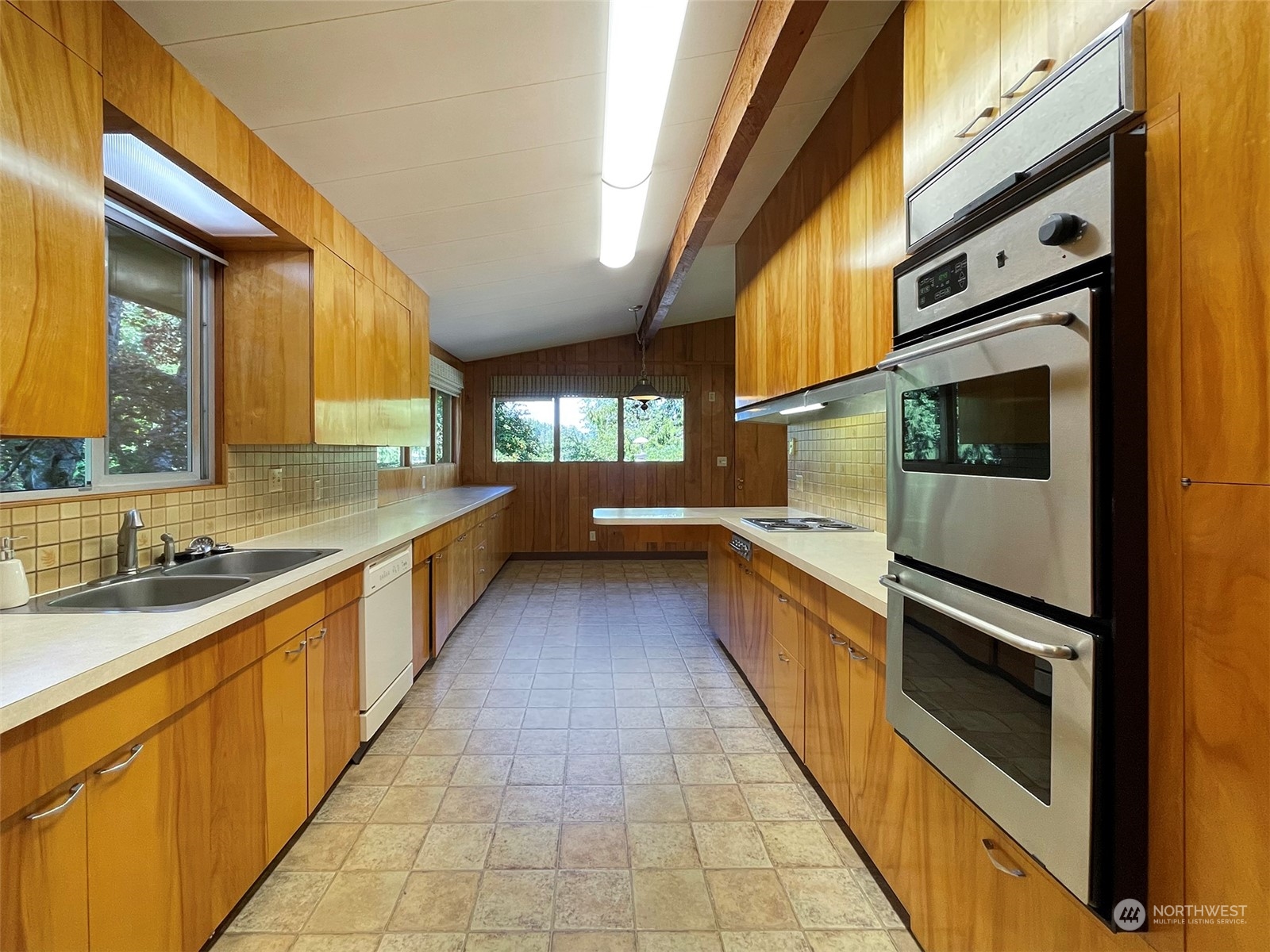 4217 South Bean Road Port Angeles, WA 98363 - Photo 14 of 40 a large kitchen with stainless steel appliances granite countertop a large stove top oven and cabinets