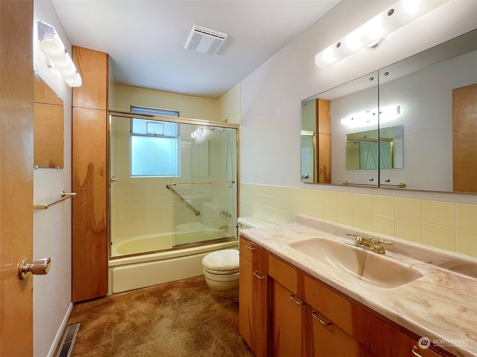 4217 South Bean Road Port Angeles, WA 98363 - Photo 18 of 40 a bathroom with a granite countertop sink mirror vanity and toilet