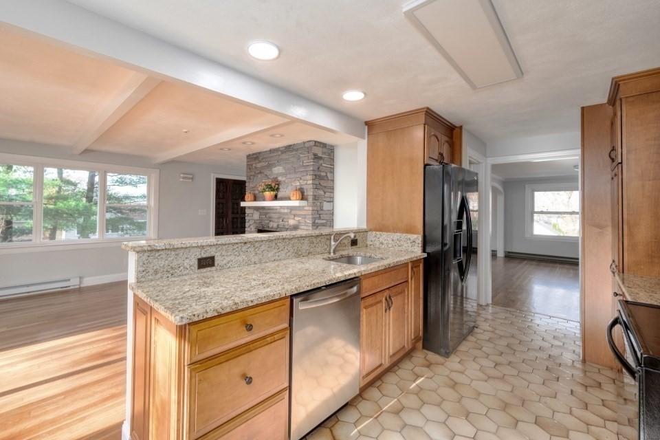 48 Conrad Street Braintree, MA 02184 - Photo 11 of 36 a kitchen with stainless steel appliances granite countertop a sink and a refrigerator