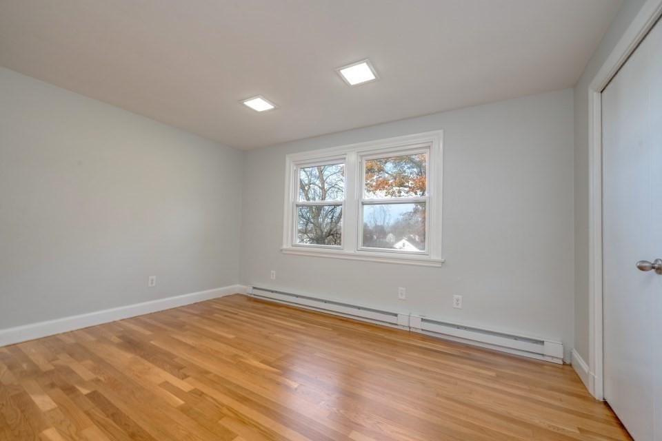 48 Conrad Street Braintree, MA 02184 - Photo 23 of 36 a view of an empty room with wooden floor and a window