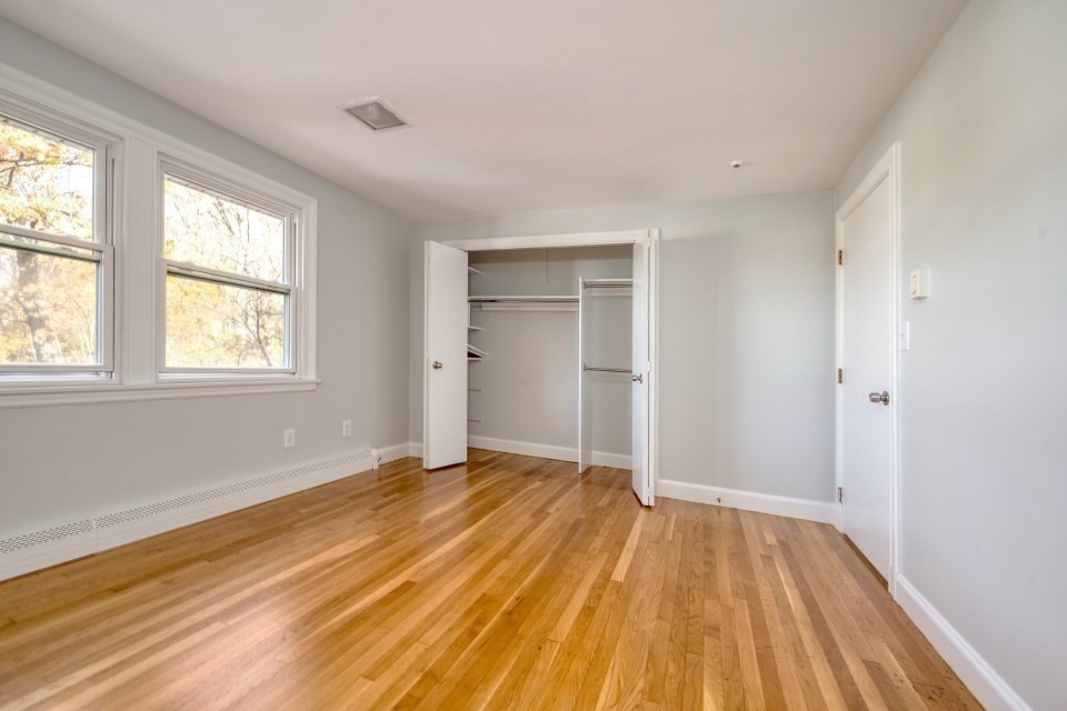48 Conrad Street Braintree, MA 02184 - Photo 24 of 36 a view of an empty room with wooden floor and a window