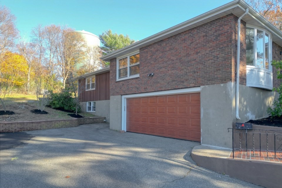 48 Conrad Street Braintree, MA 02184 - Photo 4 of 36 a front view of a house with a garage