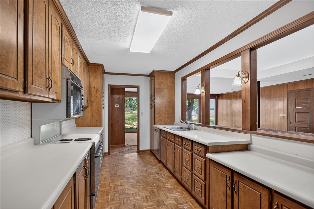 1412 Simpson Road Pendleton, SC 29670 - Photo 7 of 48 A classic kitchen with ample wood cabinetry and durable countertops, ready for your culinary endeavors.
