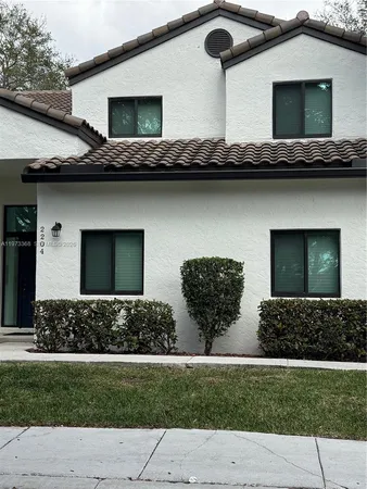 a view of house with yard and outdoor seating