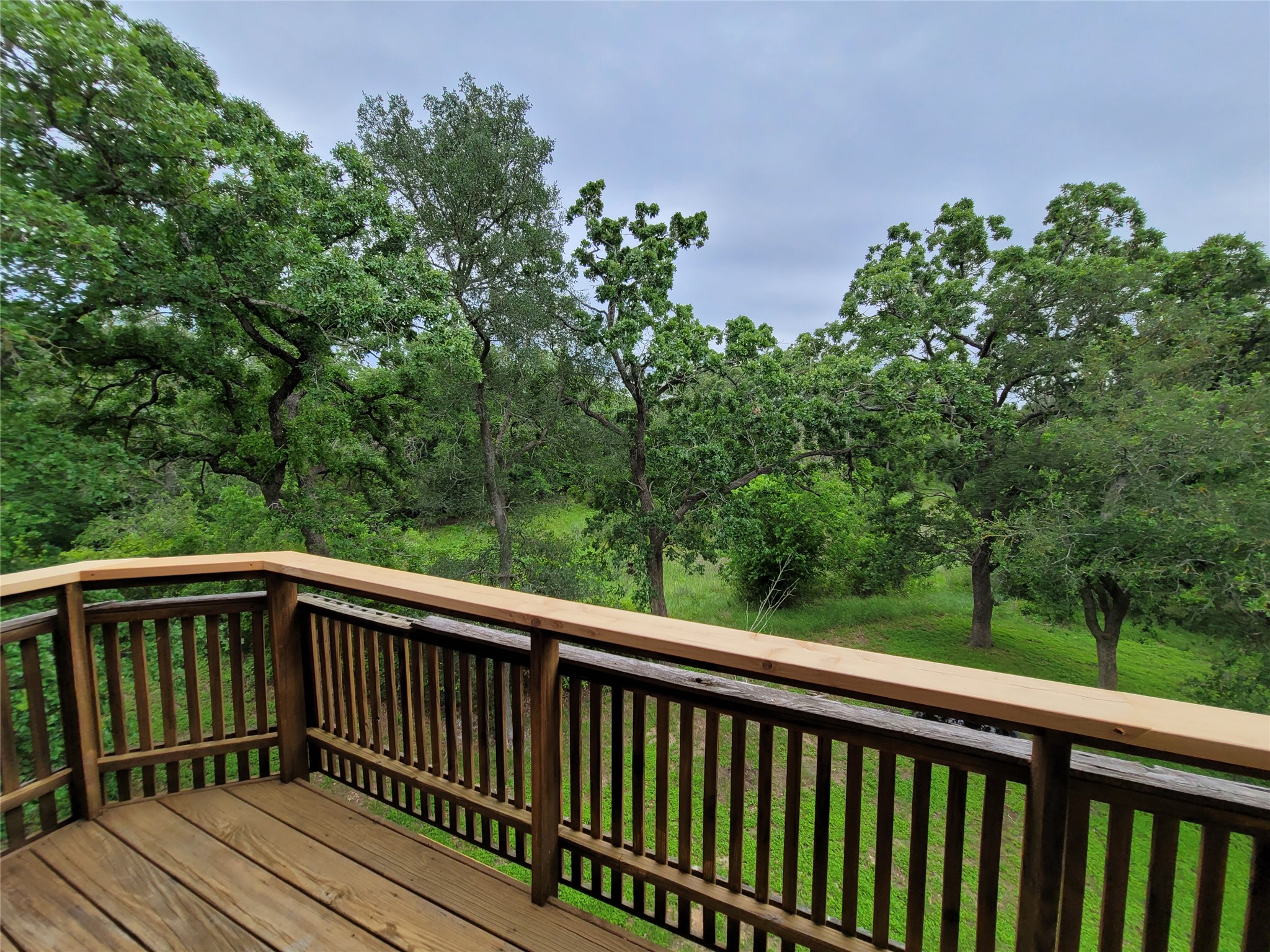 281 Earl Callahan Road, Unit A Cedar Creek, TX 78612 - Photo 35 of 39 a view of balcony with deck and wooden floor