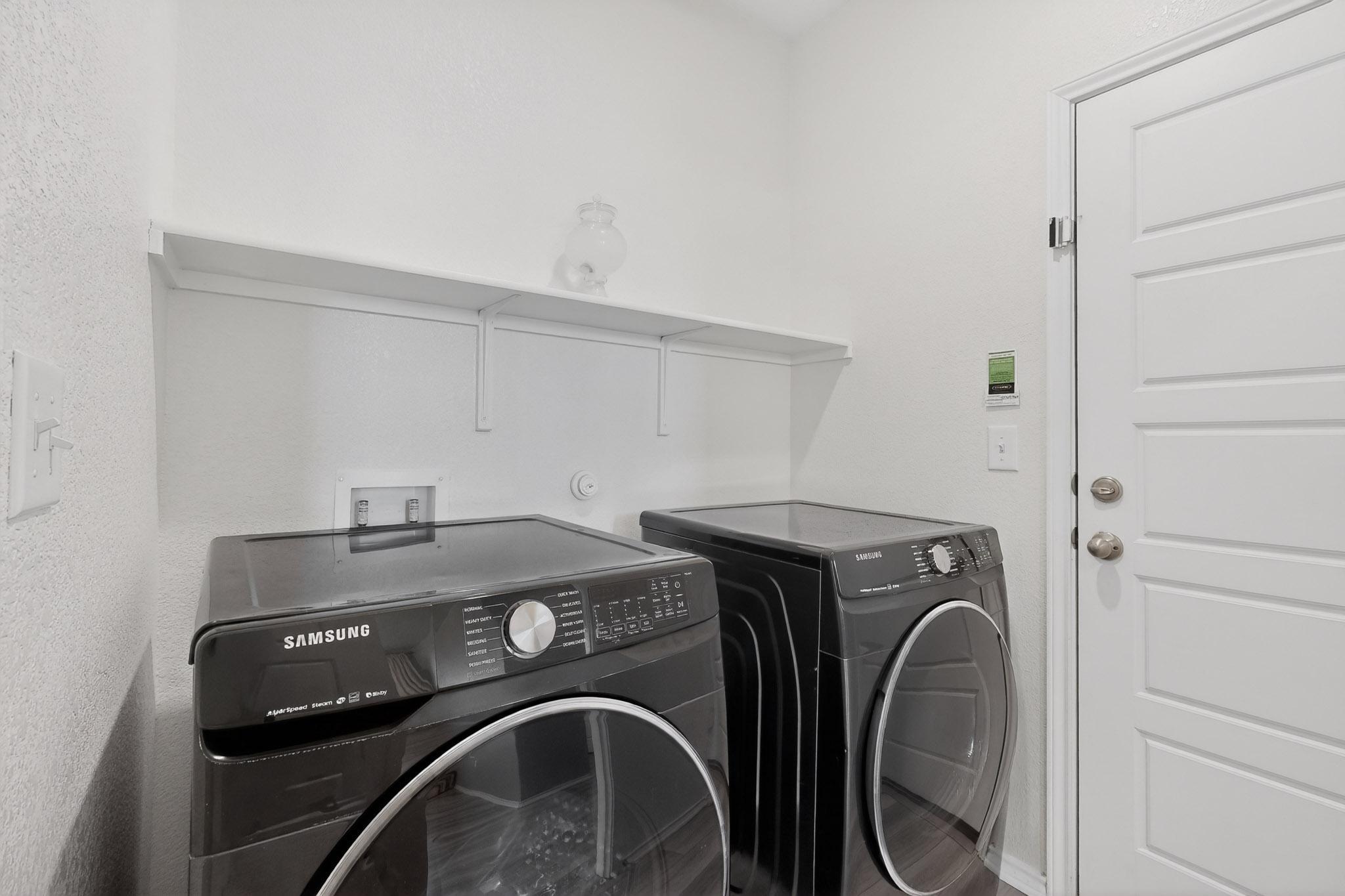 14513 Booted Eagle Pass Elgin, TX 78621 - Photo 29 of 33 Dedicated laundry room off the garage with extra area for storage or freezer. Front load washer/dryer can convey.