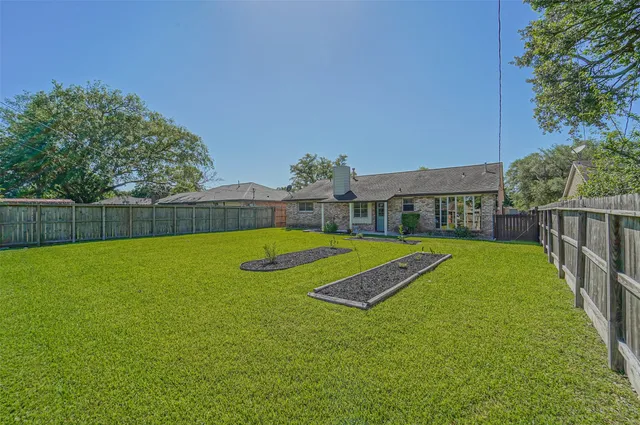 a view of a big yard with swimming pool and deck