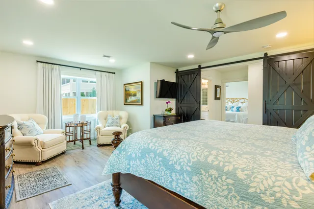 a spacious bedroom with a bed couch and a window