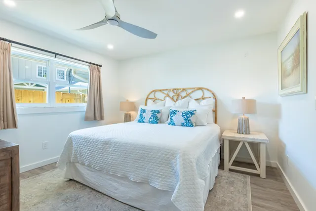 a bedroom with a large bed and a window