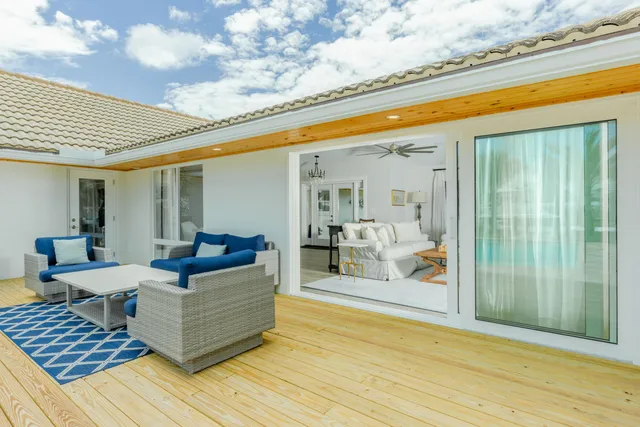 a view of a patio with couches and pool