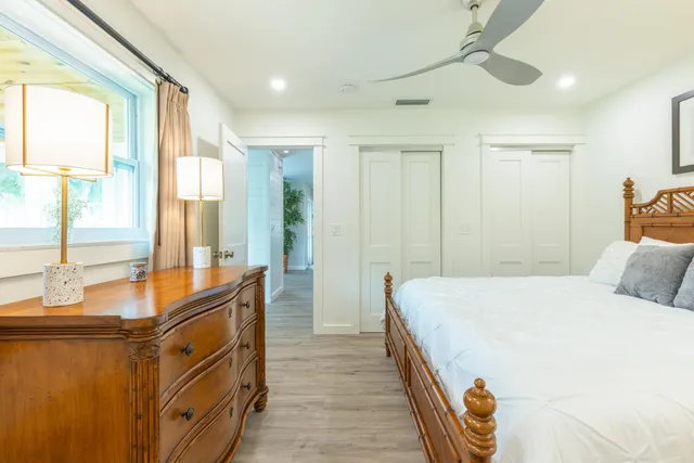 a spacious bedroom with a large bed and a large window