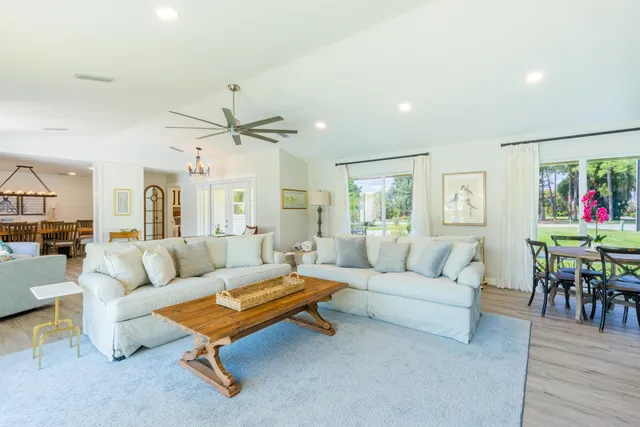a living room with furniture and a ceiling fan