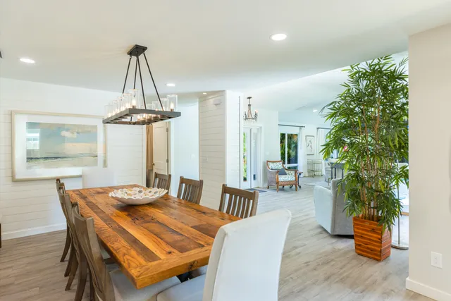 a view of a dining room with furniture and chandelier