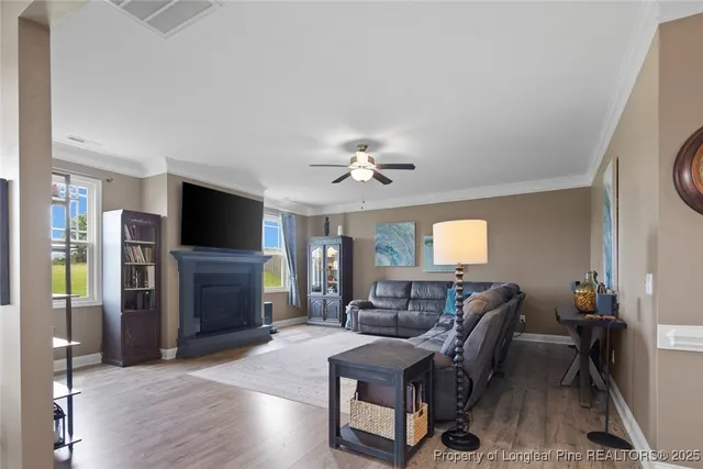 a living room with a fireplace and a flat screen tv