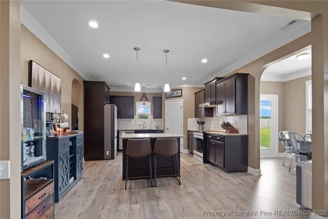 a kitchen with refrigerator and cabinets
