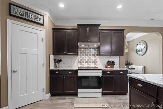 a kitchen with granite countertop cabinets and black appliances