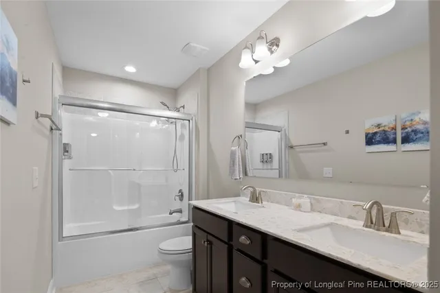a bathroom with a granite countertop shower and a sink