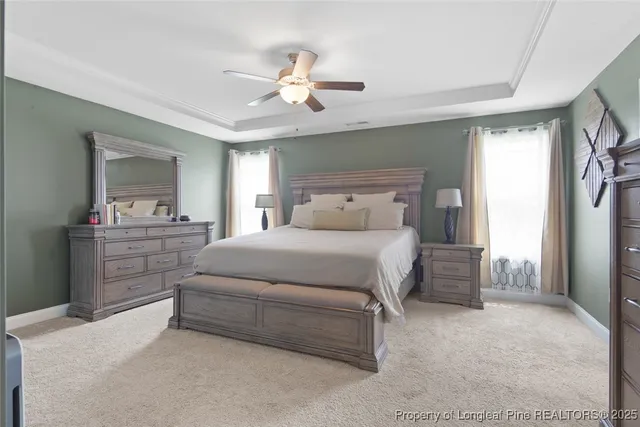 a bedroom with a bed and a ceiling fan