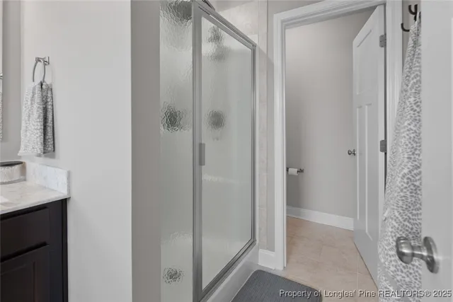 a bathroom with a tub a double vanity sink and a mirror