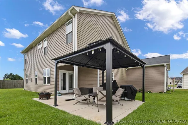 a view of a house with a backyard