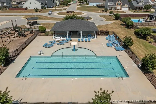 swimming pool view with a outdoor seating space