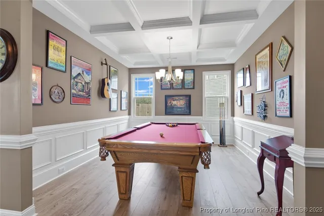 a room with pool table and a chandelier