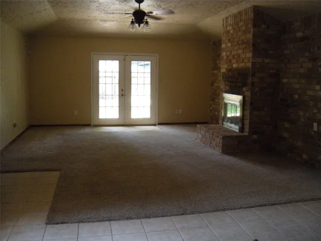 a view of a livingroom with a ceiling fan and window