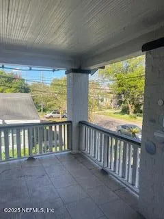 a view of a porch with wooden floor