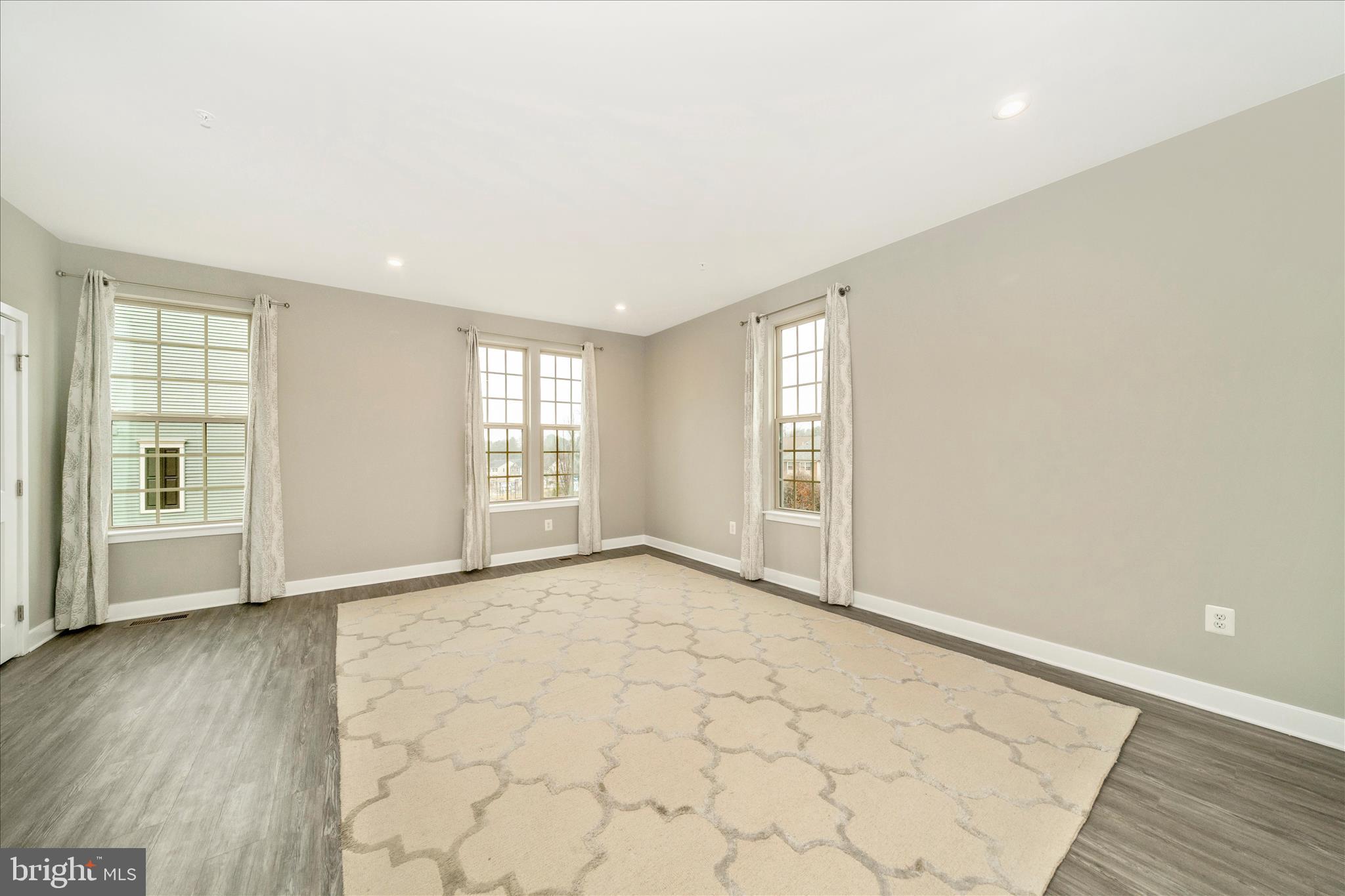 9537 Tall Oaks Road Montgomery Village, MD 20886 - Photo 12 of 53 an empty room with wooden floor and windows