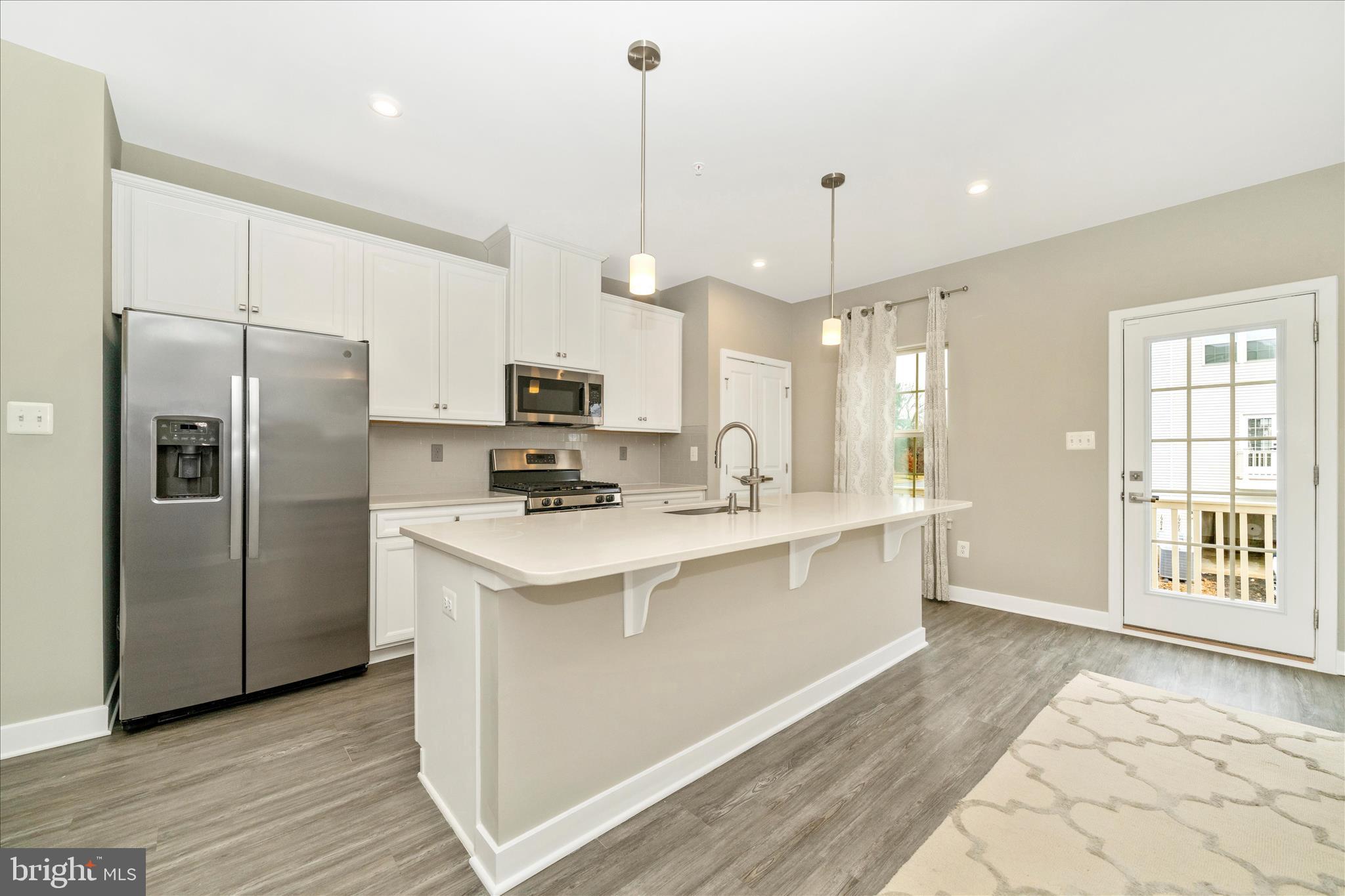 9537 Tall Oaks Road Montgomery Village, MD 20886 - Photo 17 of 53 a kitchen with stainless steel appliances a stove a refrigerator and a sink