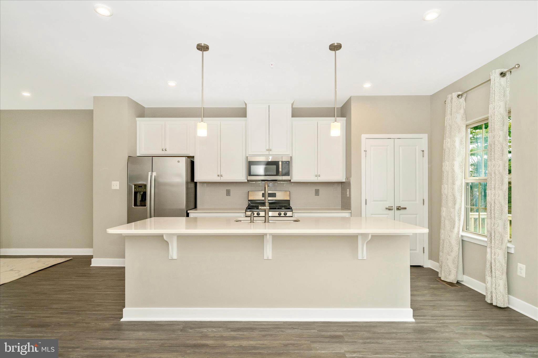 9537 Tall Oaks Road Montgomery Village, MD 20886 - Photo 20 of 53 a view of kitchen with stainless steel appliances granite countertop cabinets and a chandelier