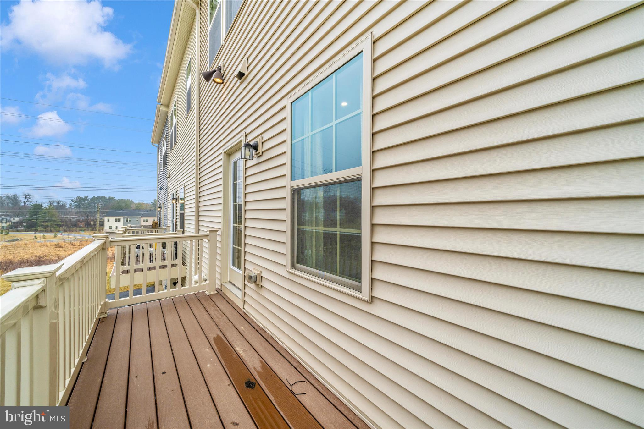 9537 Tall Oaks Road Montgomery Village, MD 20886 - Photo 42 of 53 a view of a balcony with wooden floor and fence
