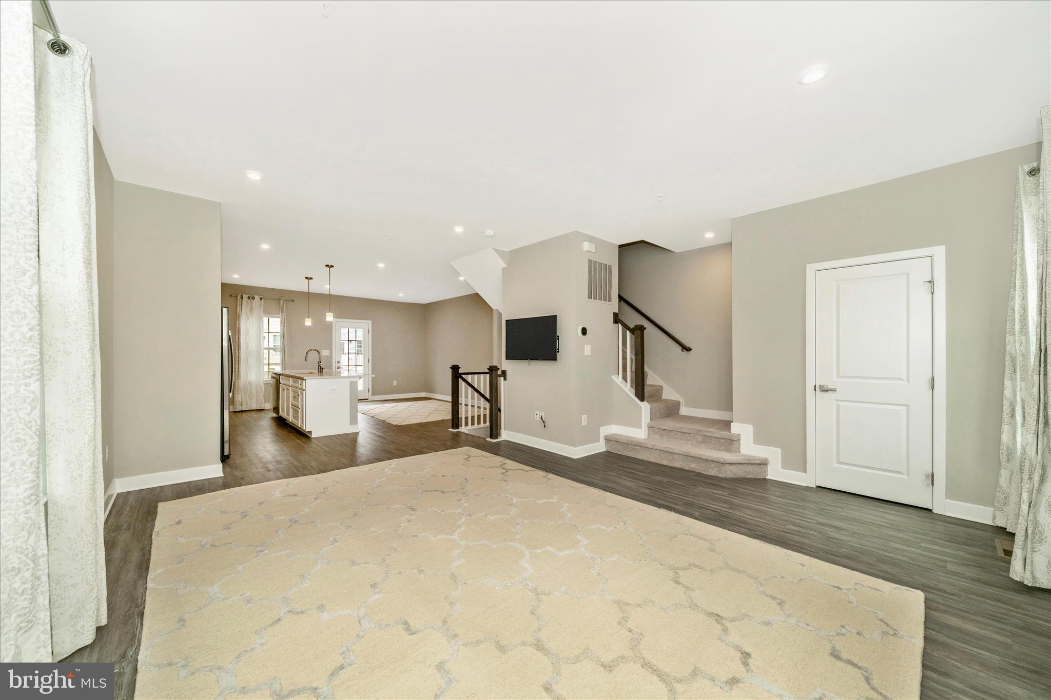 9537 Tall Oaks Road Montgomery Village, MD 20886 - Photo 10 of 53 a view of a livingroom with wooden floor and kitchen space
