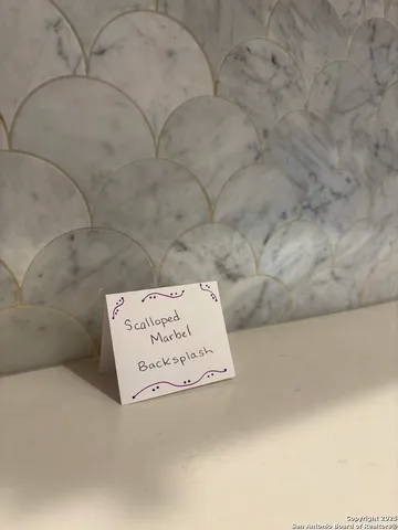 a kitchen with refrigerator and cabinets