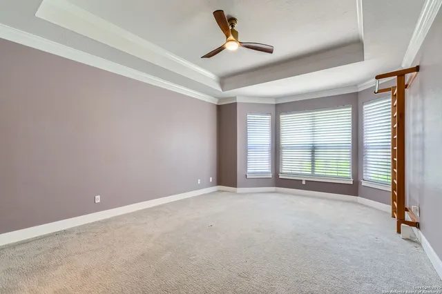 an empty room with an entryway and chandelier